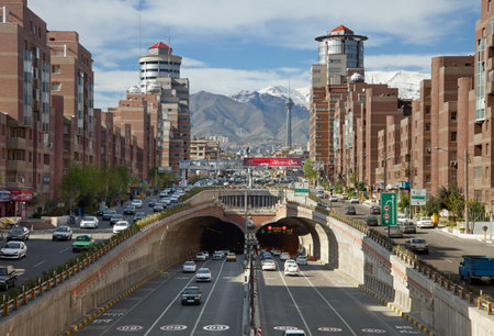 Cars Passing Through Tohid Tunnel of Tehran with Milad Tower and Alborz Mountains in the Background.のeditorial素材