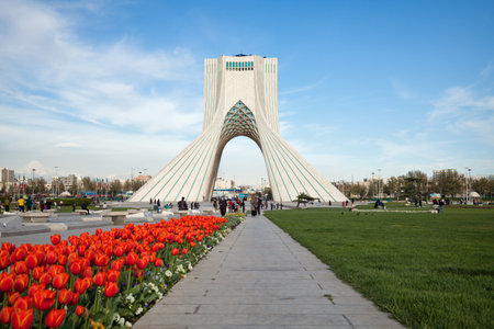 Azadi Square decorated with grass and red tulips in springtime. Azadi Monument is the most famous landmark of Tehran situated in the center of Azadi sq.のeditorial素材