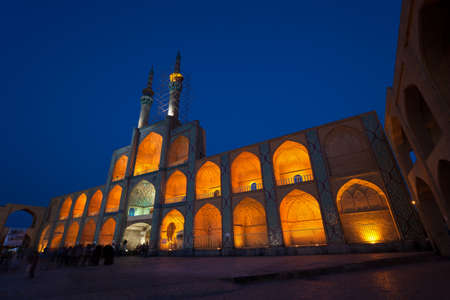 Facade of illuminated Amir Chakhmaq mosque situated in a square with similar name, against dark blue sky in the city of Yazd.の写真素材