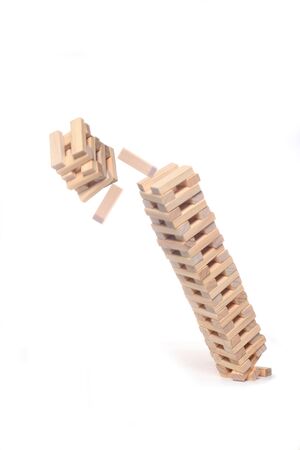 wooden blocks toy falling down isolated on white background with copy spaceの写真素材