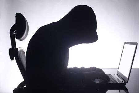 hacker sitting at the desk with copy space for your textの写真素材