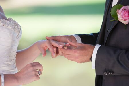 The bridescouple, bride and groom, exchaning the wedding rings during their wedding ceremonyの写真素材