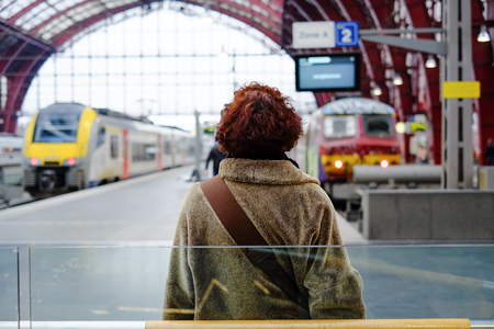Trains and travellers in a railway stationの写真素材