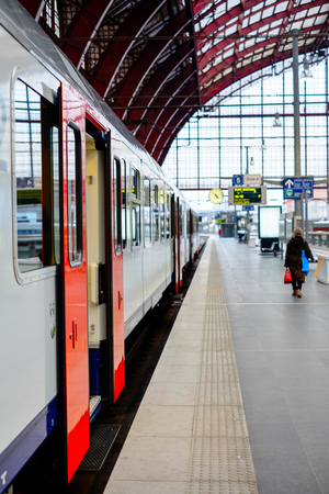 Trains and travellers in a railway stationの写真素材
