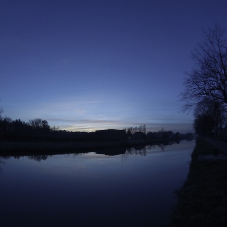 Colorful sky at sunrise reflected in the water of the riverの写真素材
