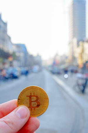 Bitcoin payment in a shopping street or store using cryptocurrency in real life conceptの写真素材