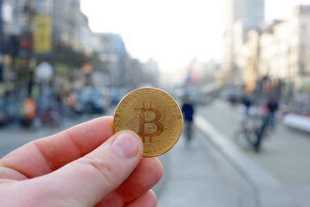 Bitcoin payment in a shopping street or store using cryptocurrency in real life conceptの写真素材