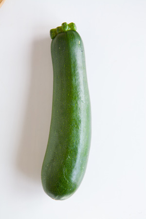 Fresh vegetables, green zucchini on a white background top viewの写真素材