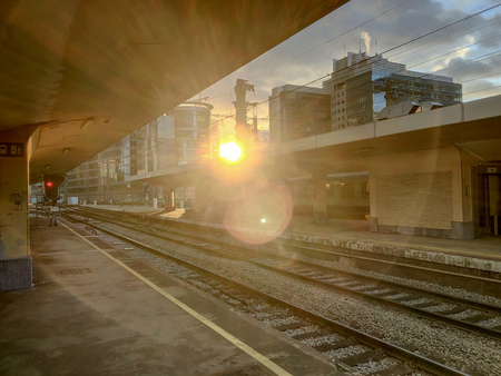 Brussels, Belgium anno 2019: Commuters waiting on the platform next to the empty rails in the...