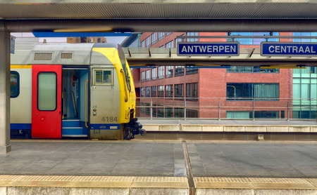Trains coming in and out of the big dome of the beautiful, historic and monumental Antwerp Train Station as seen from the outside part of the platforms. Antwerp Central is often considered to be one of the most beautiful railway stations in the world.のeditorial素材