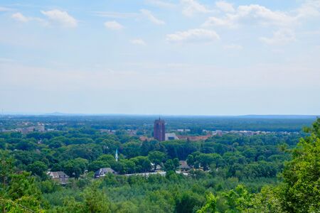 Amazing image of all the nature on a sunny day with a blue sky and white clouds above all the forests in Maasmechelen Belgiumの写真素材