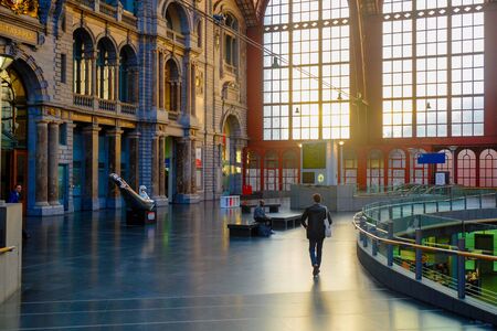 Antwerp, Belgium - June 2019: Internal facade in the Interior of Antwerp Central Train station with sun shining through the glass windowsのeditorial素材