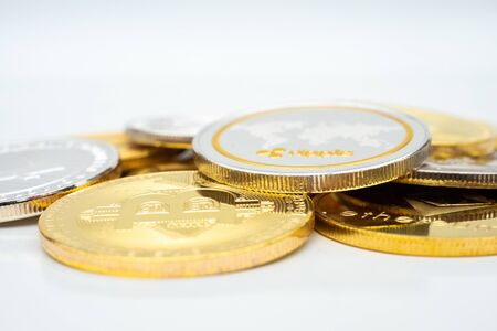 Bunch of Crypto currency coins with various of shiny silver and golden physical cryptocurrencies symbol coins, Bitcoin, Ethereum,. Litecoin, Monero, ripple with focus on BTC Bitcoinの写真素材