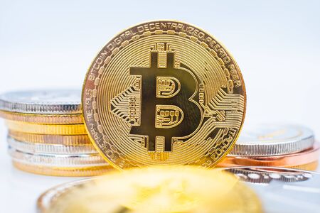 Bunch of Crypto currency coins with various of shiny silver and golden physical cryptocurrencies symbol coins, Bitcoin, Ethereum,. Litecoin, Monero, ripple with focus on BTC Bitcoinの写真素材