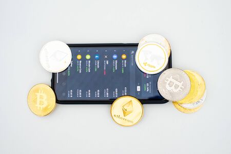 Cryptocurrency stock market app open on a smartphone depicted with some of the current...