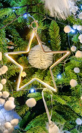 Close up of beautifully decorated Christmas ornament decorations in a Christmas tree with golden and...