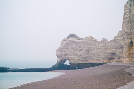 Misty morning landscape of the Natural white chalk cliffs in Etretat, Normandy, France, La Manche or English Channel, on the Coast of the Pays de Caux area.の写真素材