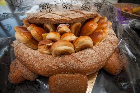 Bunch of sliced French breads and sandwiches in a basket.