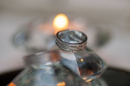 Close-up of two Wedding rings on a diamond shaped crystal or glass on a weddings day の写真素材