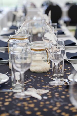 Festive dining table setting, with candles in glass jars, hearts and colors, vintage crockery and...