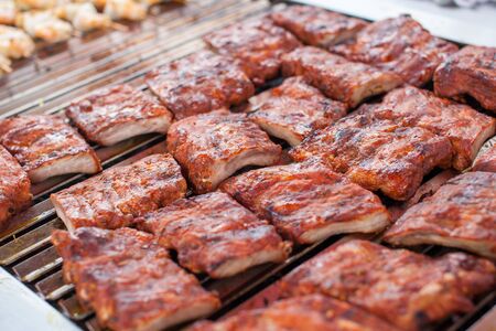 Outdoor picnic scene of bbq with delicious spare ribs on a grillの写真素材