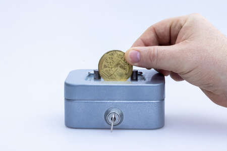 Little saving vault, hand holds golden bitcoin coin virtual money. Cryptocurrency, business and saving concept. High quality photoの写真素材