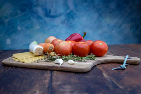 Different ingredients for cooking Italian lasagna on a wooden background. High quality photoの写真素材