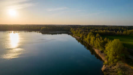 Stunning aerial drone landscape image of sunset or sunrise in spring over Europese countryside. High quality photoの写真素材