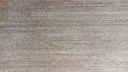 Aerial view geometric farming fields, showing a green meadow and plowed fields, captured with a...