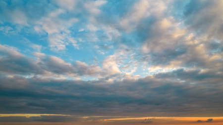 Sunset with dark and dramatic tthunderstorm clouds being split. The light from the setting sun...