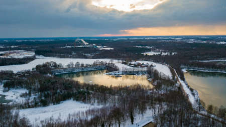 Aerial view of the winter snow covered forest and frozen lake from above captured with a drone. High quality photoの写真素材