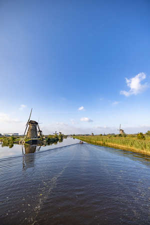 Vertical picture of one of the famous Dutch windmills at Kinderdijk, a site. On the photo is one mill of the 19 windmills at Kinderdijk, South Holland, the Netherlands, which are built in 1738 and 1740. High quality photoの写真素材