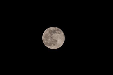 Super full moon with dark black background for placement in video, banner, shot in march 2022, Antwerp, Belgium. High quality photoの写真素材