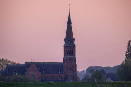 Prosperdorp, Hulst, Netherlands, 20th of april, 2022, Purple Sky over Prosperdorp Church and Town. High quality photoのeditorial素材