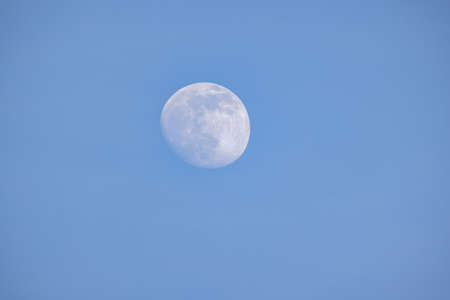 Night sky with full bright moon in the clouds . High quality photo
