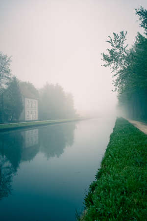 Beautiful spring sunrise over river banks. Morning fog in the forest. High quality photoの写真素材