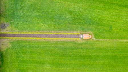 garden detail in aerial view with sand path going between two hedges towards a little building, a shed or chapel, in the middle. High quality photoの写真素材