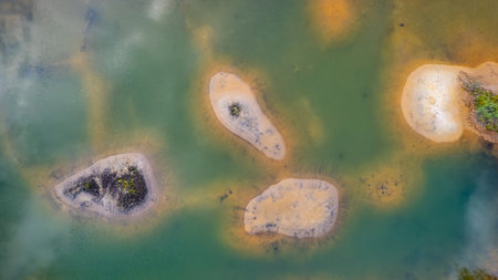 Great aerial view of opal blue water and an isolated little island. The water is crystal clear,...