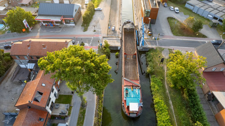 Rijkevorsel, Belgium, 19th of september, 2022, Little village of Sint Jozef, on the canal Dessel Schoten aerial photo during morning sunrise in Rijkevorsel, kempen, Belgium, showing the waterway in the natural green agricultural landscape. High quality photo. High quality photoの写真素材