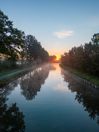 Aerial view of a colorful dramatic sunrise sky over a canal in Belgium. Canals with water for transport, agriculture. Fields and meadows. Landscape. High quality photo. High quality photoの写真素材