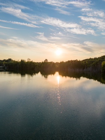 Aerial panorama Early Sunrise over forest lake. Noctilucent night clouds, summer foggy lake reflects sky. High quality photoの写真素材