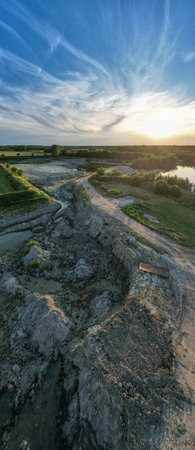 Aerial view, shot by a drone of a beautiful summer landscape, green fields, trees and the setting sun against the blue sky. Beerse, Belgium. High quality photoの写真素材