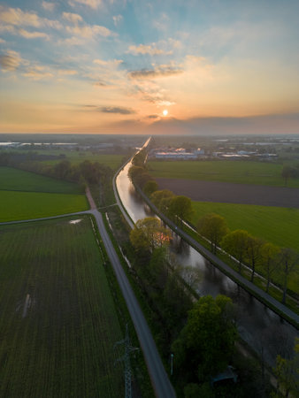 Dramatic sunset over canal Dessel Schoten aerial photo in Rijkevorsel, kempen, Belgium, showing the waterway in the natural green agricultural landscape. High quality photo. High quality photoの写真素材