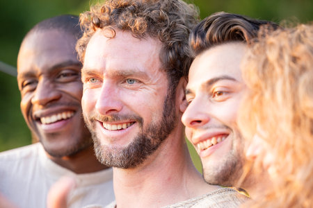 Multiracial group of friends having fun together on city street - Millenial people laughing hugging outside - Friendship concept with guys and girls enjoying hanging outside . High quality photoの写真素材