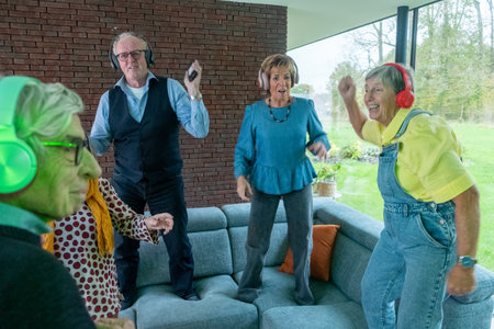 This lively image captures a group of seniors enjoying a silent disco, each wearing headphones and...