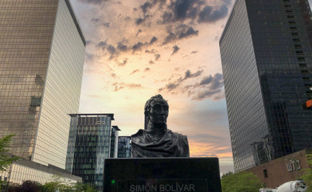 Brussels, Belgium, 28th of May, 2019, This compelling image showcases the statue of Simon Bolivar, the iconic South American liberator, set against a dramatic sunset sky in the Simon Bolivar square near Brussels North railway station. The statue is the ceのeditorial素材