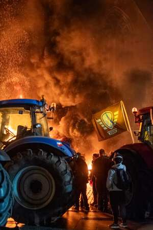 Turnhout, Antwerp, Belgium, 28th of January, 2024, The image vividly captures a dynamic and intense moment during a farmers protest against the Nitrogen Agreement in Turnhout, Belgium. A group of protestors is seen amidst thick plumes of smoke, with the fのeditorial素材