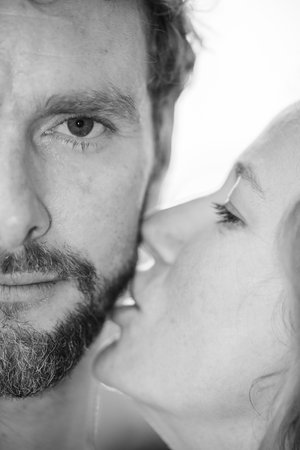 A monochrome image captures a couples intimate moment, revealing their deep emotion and strong connectionの写真素材