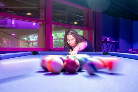 A highly skilled pool player meticulously aiming at the pool table, immersed in vibrant, colorful...