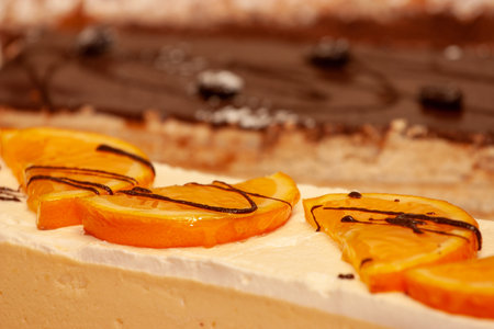 A delicious dessert with creamy layers, topped with juicy orange slices and delightful chocolate...